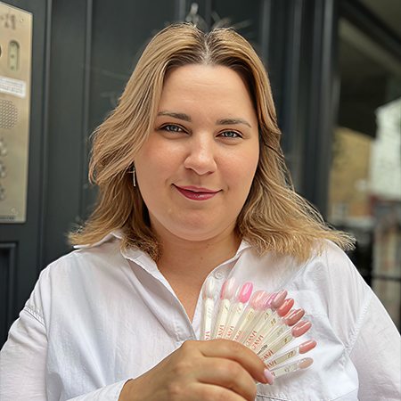 Happy woman showing nail care packet